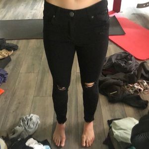 Black jeans with holes kind of and a cut off look at the ankle